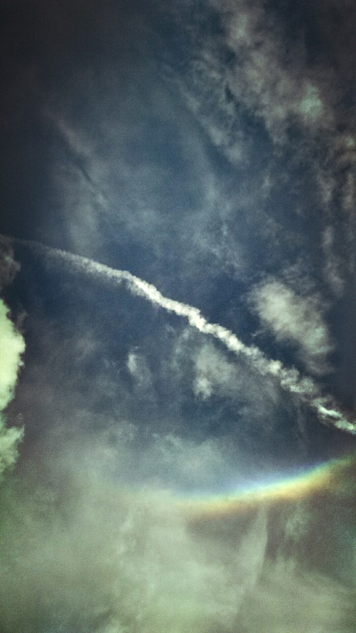 Cloud trail and rainbow