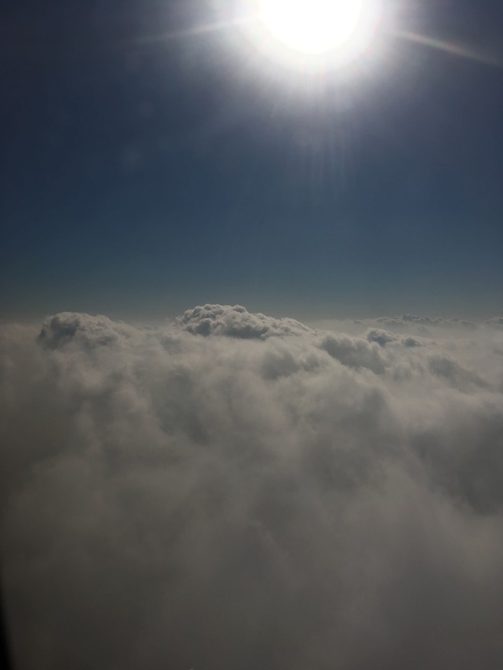 cloudy sky from airplane window