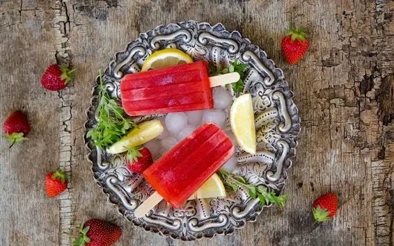 strawberry popsicles and lemon on ice