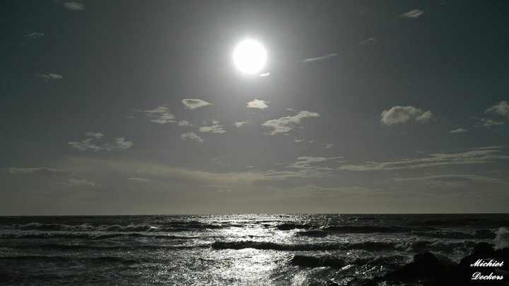 Dark sun shining on the sea