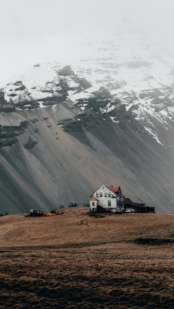 a lonely home between mountains in a valley