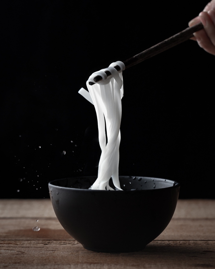 white noodle holding with chopsticks
