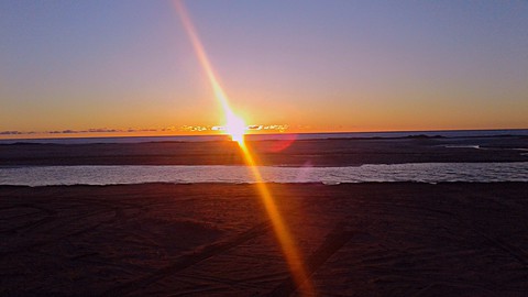 Driving by the beach at sunset