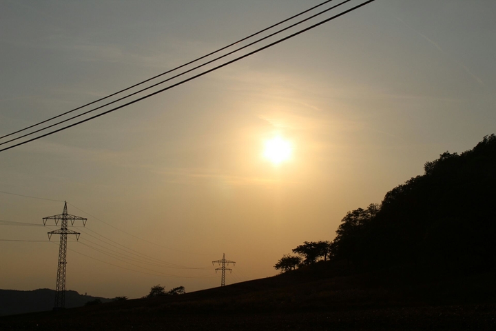 Sunset between high voltage
