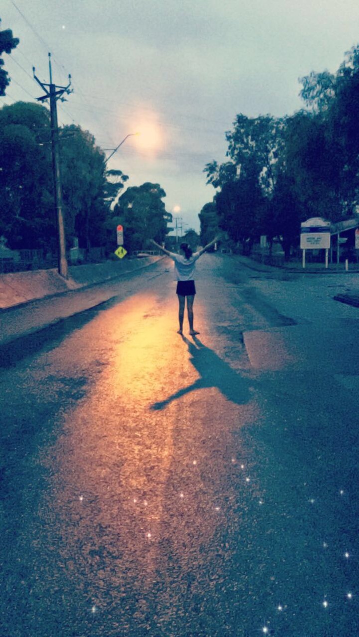 A girl standing on the road