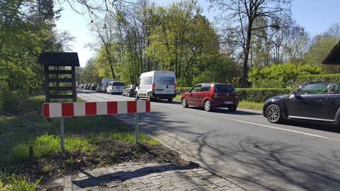 20 cars standing on a rail crossing.