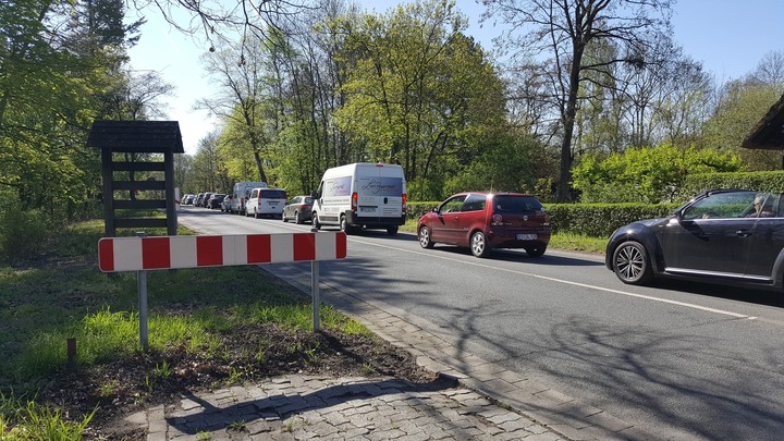 20 cars standing on a rail crossing.