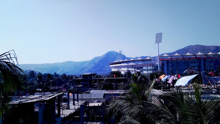 a stadium front of a hill