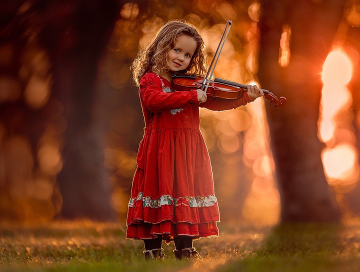 cute girl baby plays violin