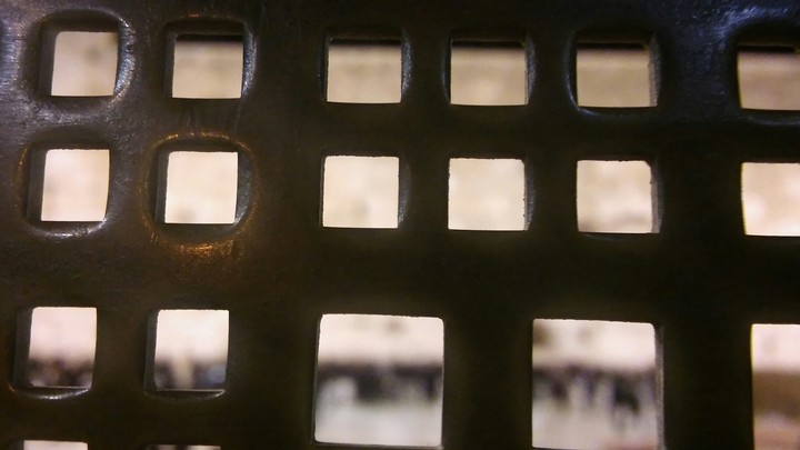 the kottel (The Western Wall) beyond the bars