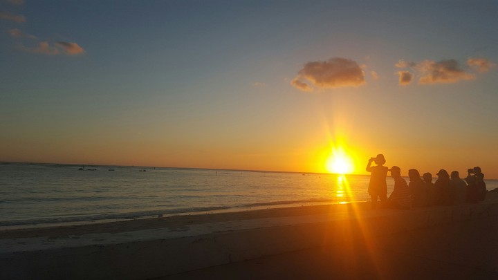 Crowd watching sun setting