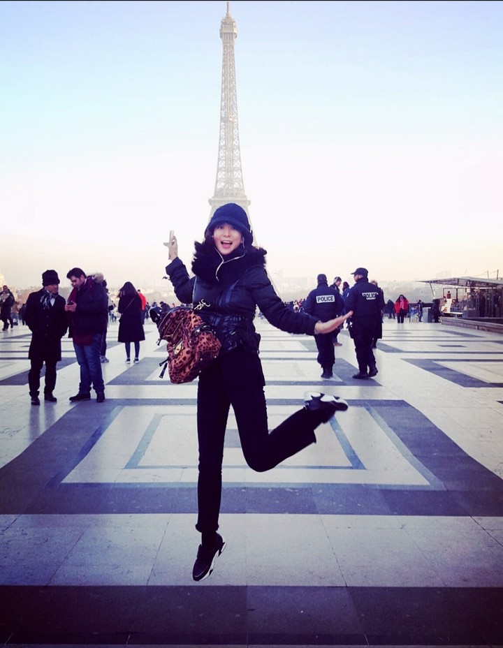 Girl jumping in front of Paris Eiffel Tower
