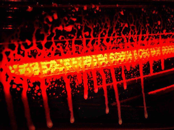 Red light sprayed with cleaning liquid