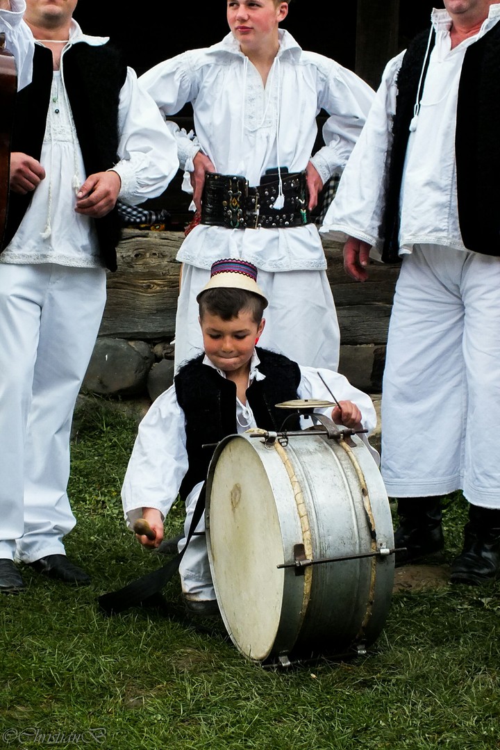 child singing a traditional instrument, as seen in Maramures