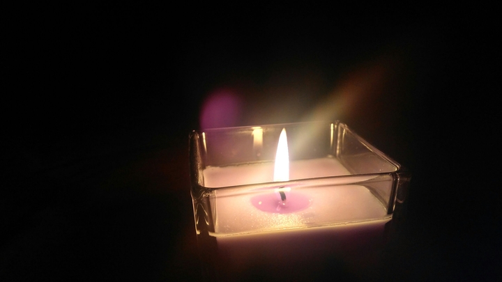 Candle in darkness.