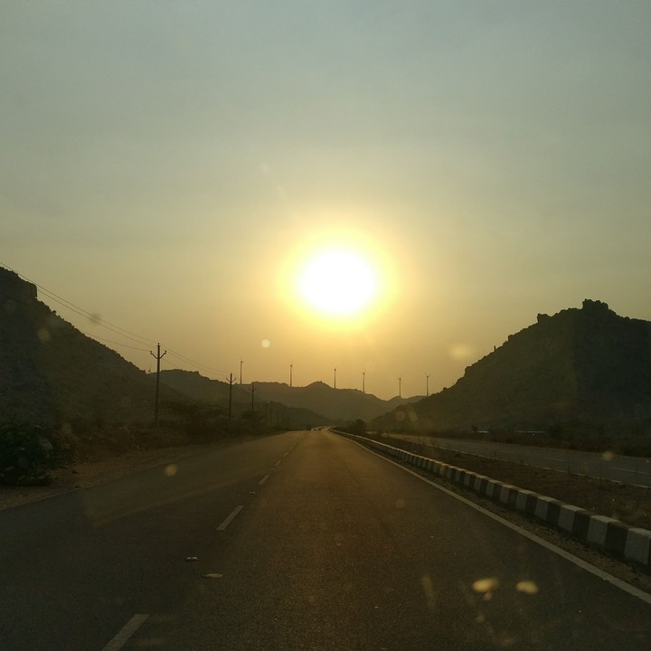 sunset and windmills at far