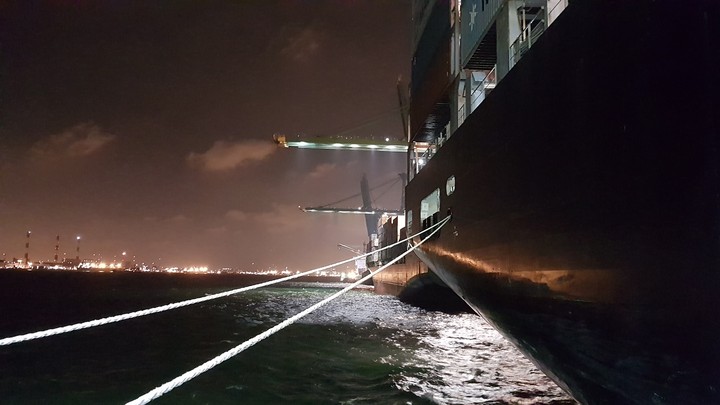 Night fishing view next to a container ship