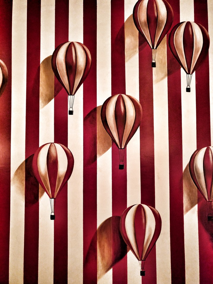 A Wallpaper of Patterns and Balloons imprinted on it.