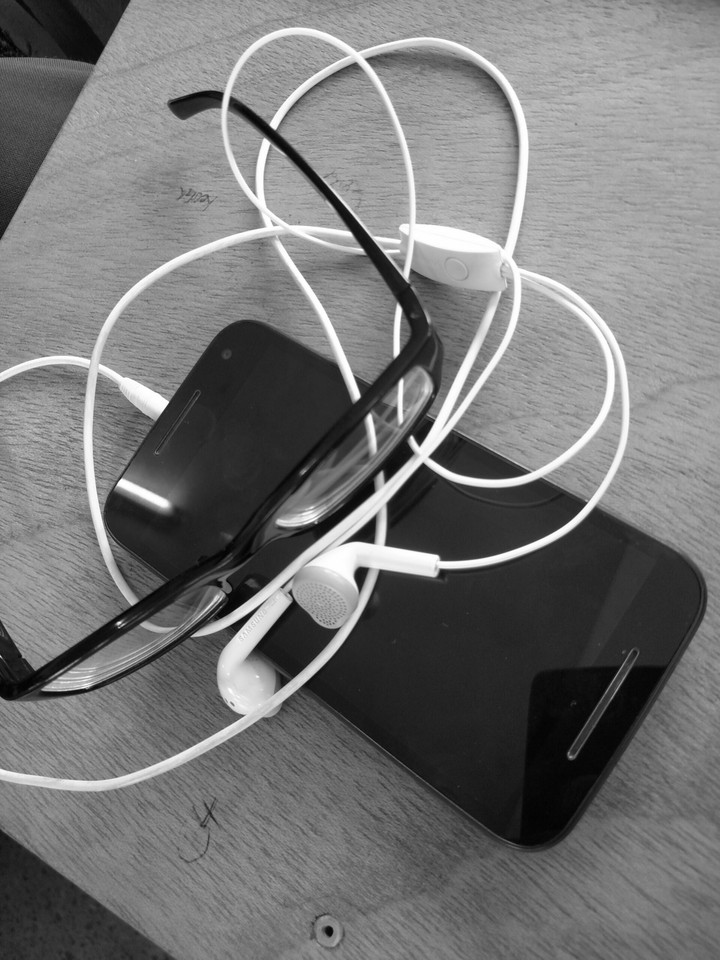phone, earpieces, glasses