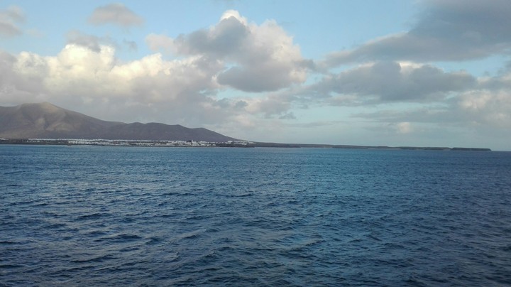 island sea clouds edge