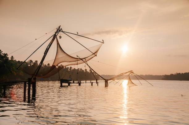 Fishing Nets In Lake Against Sky During Sunset - stock photo