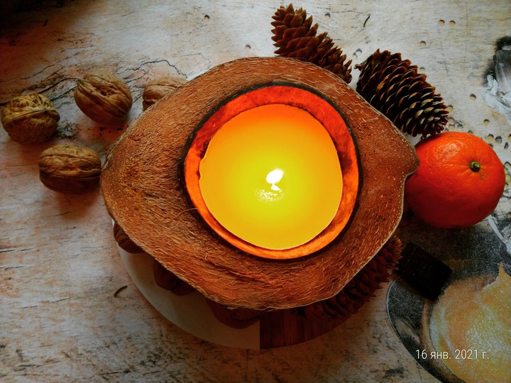 Candle, coconut, nuts, spruce cones