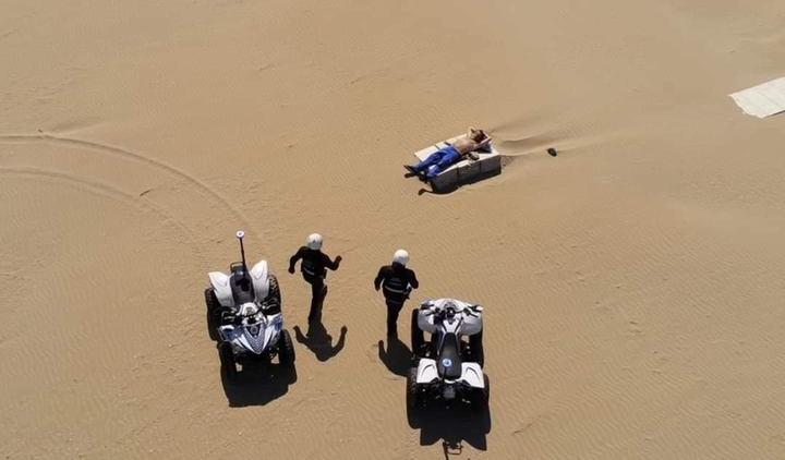 Doctors coming to check med condition of patient in desert !