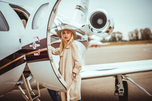 Young rich blonde female looking over her shoulder while -