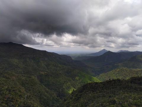 Green mountains covered with Ice clouds .