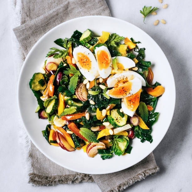 Fresh salad with boiled eggs - stock photo