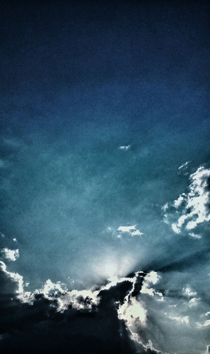 a sun behind the clouds
