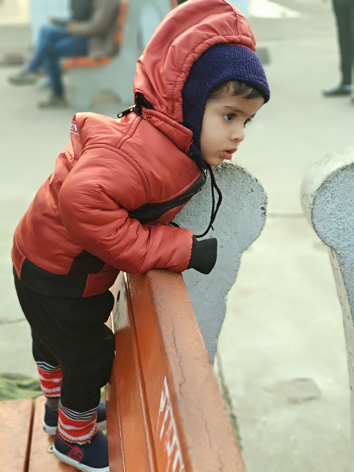 Cute Child waiting for train on station in winter