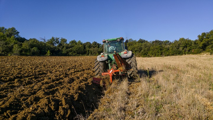 John Deere plowing
