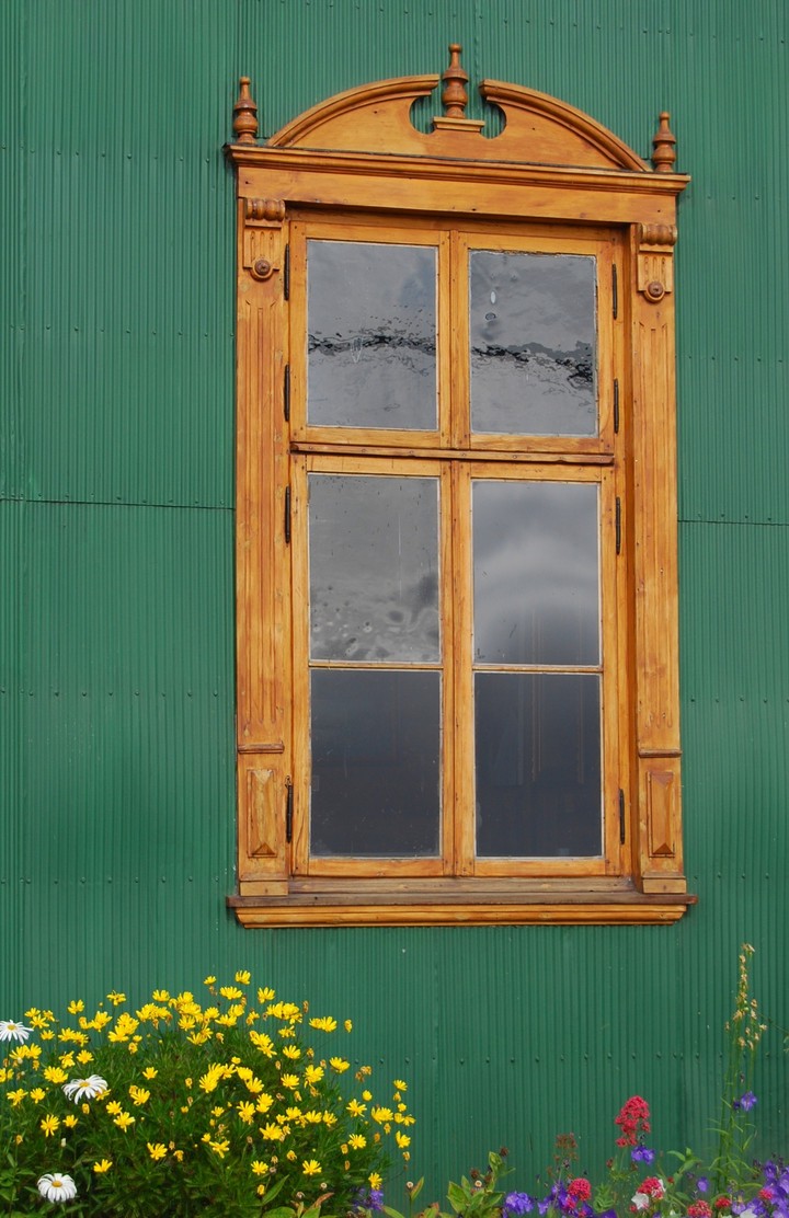 window in the green wall