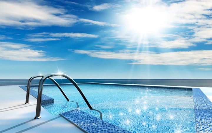 SWIMMING POOL ILLUMINATED BY THE SUMMER SUN