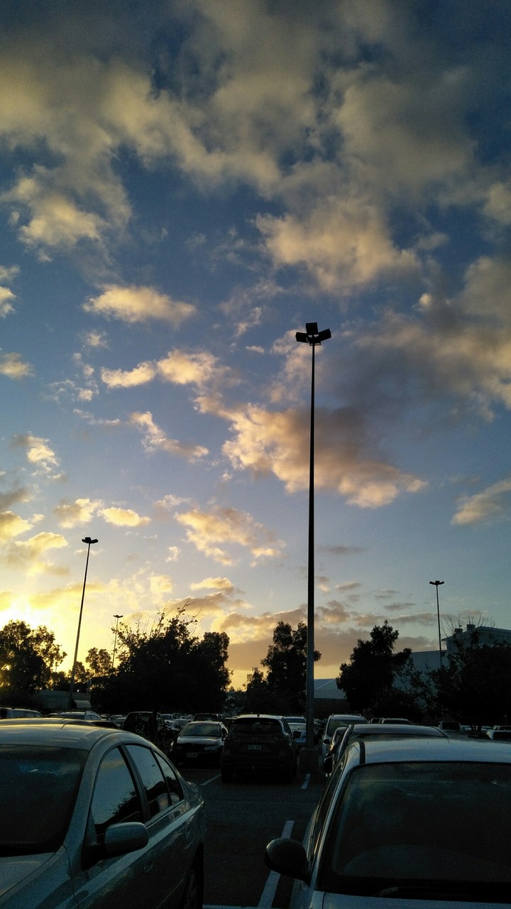 Sun setting in a parking lot