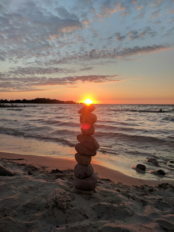 Rock balancing at sunset