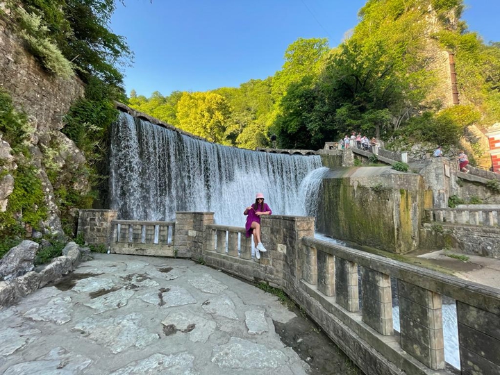 by the waterfall
