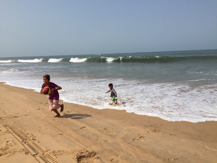 Playing kids at a beach.