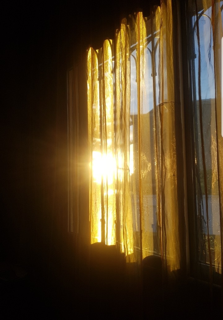 sunset snd ripped gold curtain