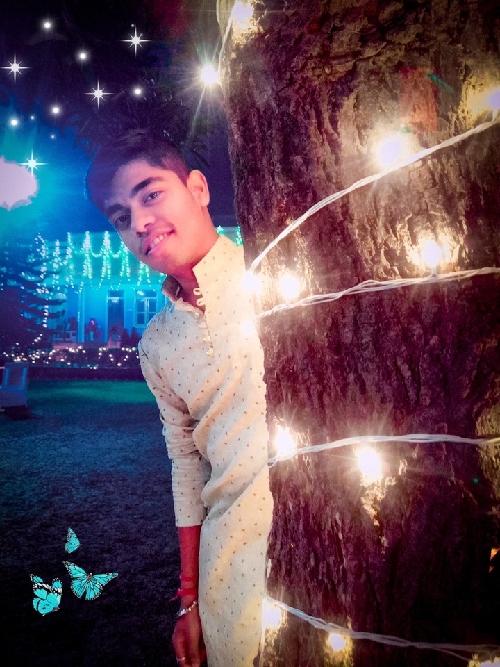 smiling boy behind the tree