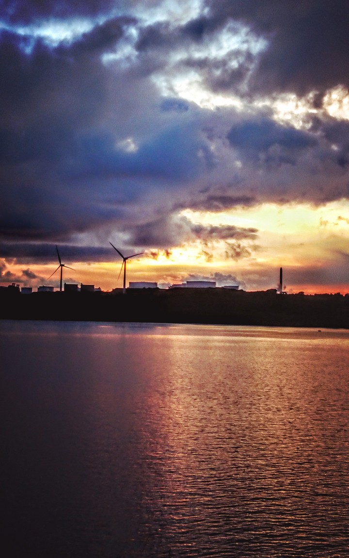 sunset over the refinery