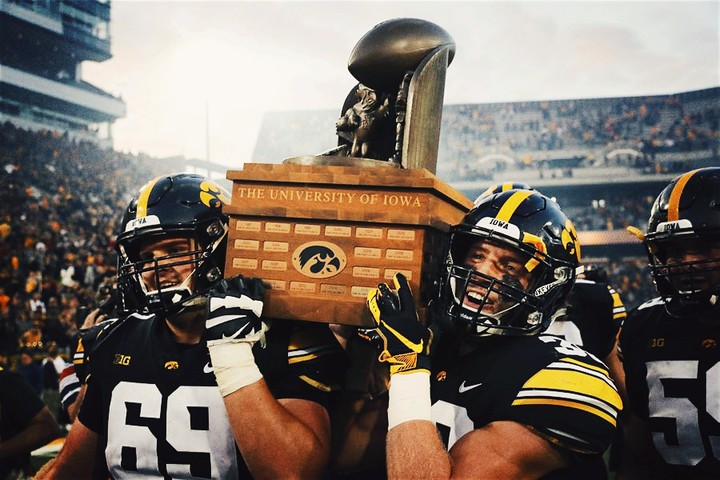 Iowa Hawkeyes hoisting the Cyhawk Trophy 2018