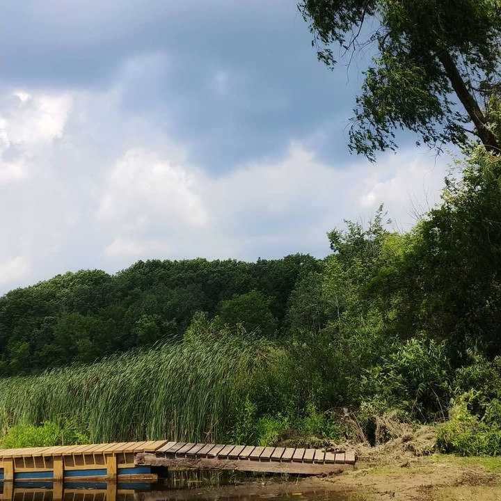 sitting by the dock of the lake