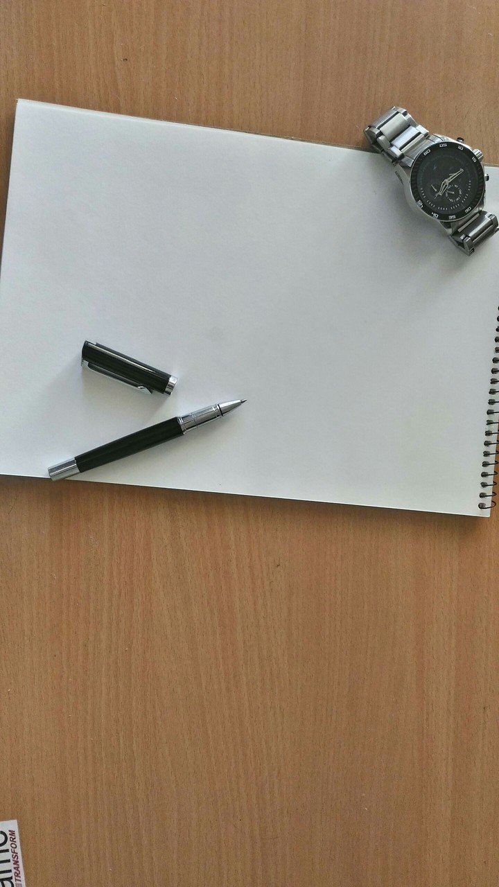 dashboard with pen watch and a notepad