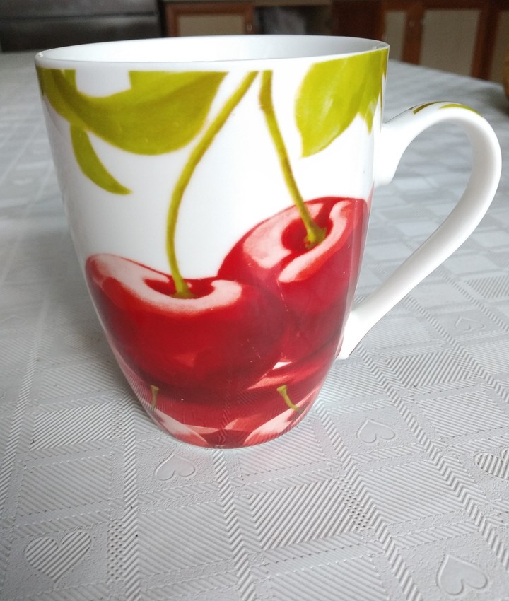 Tea cup with cherries