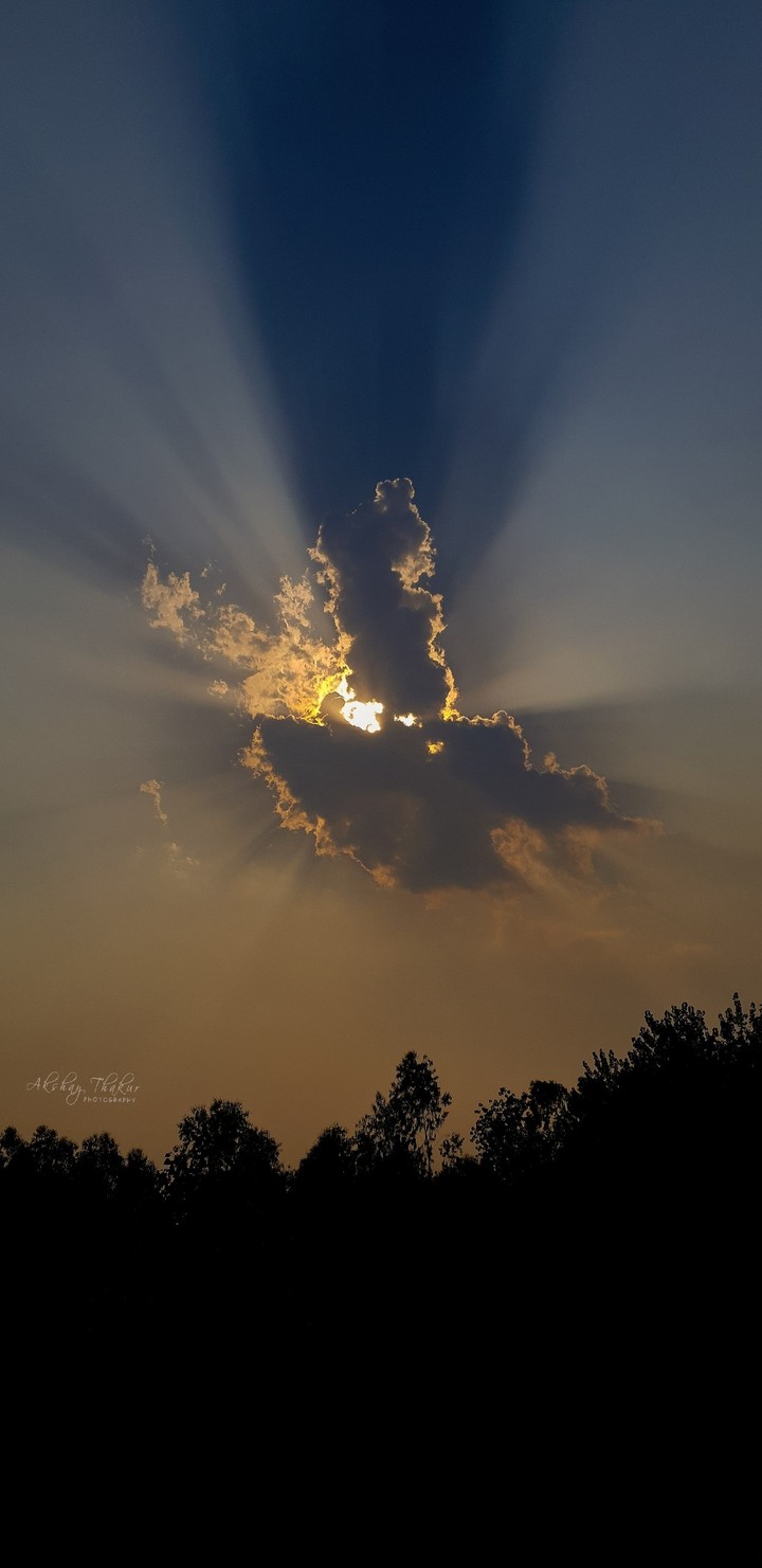 sun behind clouds