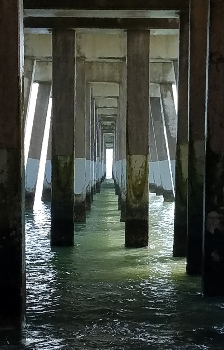 Under the pier.
