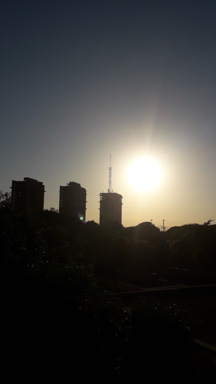 Three buildings in the sunset