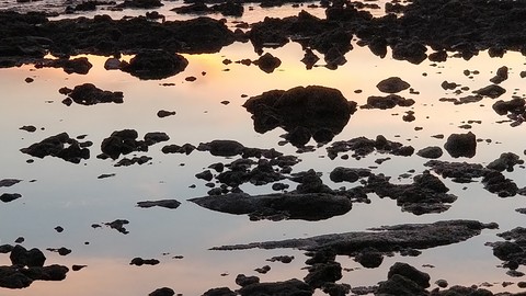 Tides reveille's the rocks doring sunset